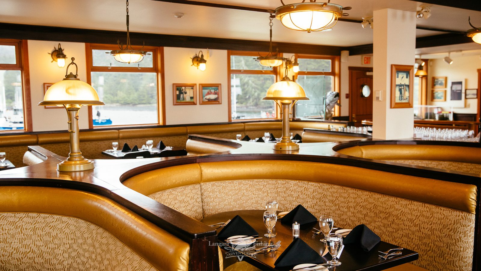 The lodge dining room, with booths and windows looking out over the water.